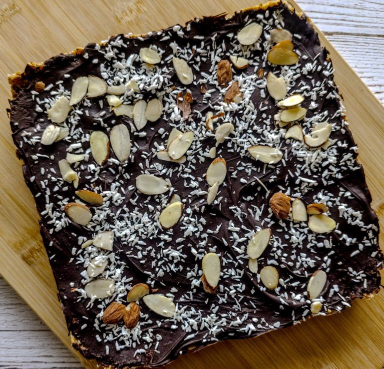 Chocolate Almond Coconut bars on a wooden tray'